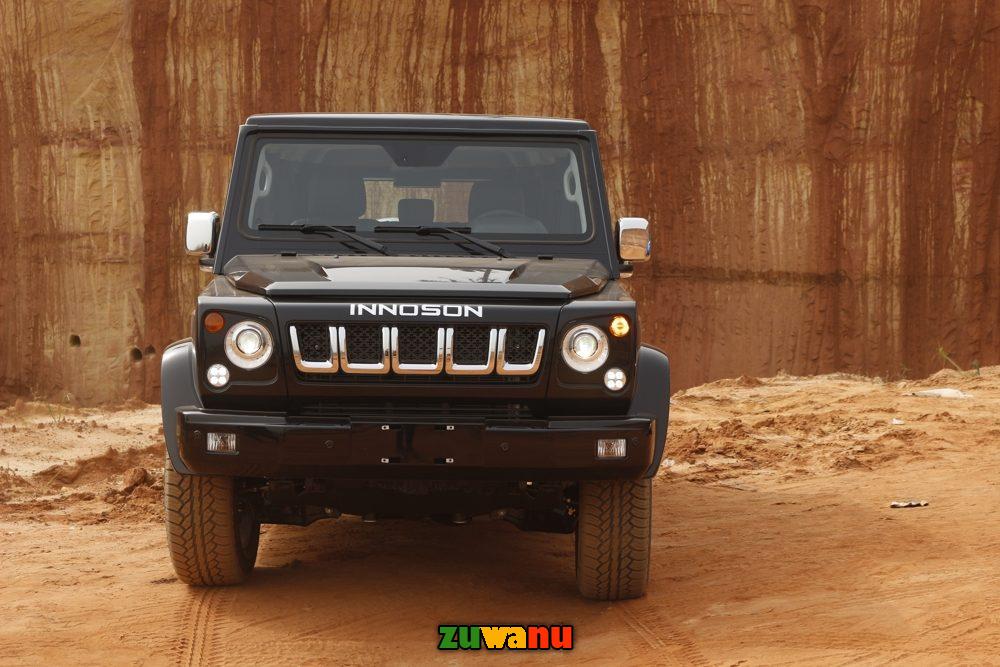 a black jeep parked in a dirt area